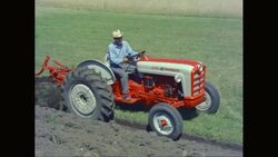 WS TS Farmer driving tractor while roller harrow ploughing in field / United States Stock Footage