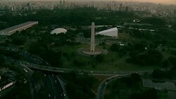 Traffic travels past an obelisk and the Ibirapuera Auditorium in Sao Paulo, Brazil. Stock Footage