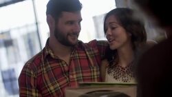 Young couple bring vinyl records to checkout counter in music shop Stock Footage
