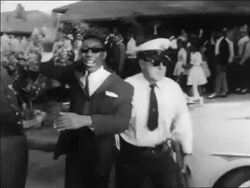 B/W 1963 policeman arresting clapping Black man with sunglasses at civil rights protest / Alabama Stock Footage