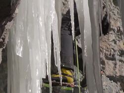 CU TU Shot behind steep icicles as man climbing / Ouray, Colorado, United States Stock Footage