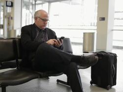 MS Middle aged businessman using cellular phone inside airport / Minneapolis, Minnesota, United States Stock Footage