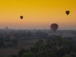 Aerial shot of hot air balloons gliding over temples and jungle Stock Footage