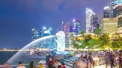 Pan Away from Tourists at Merlion Statue at Night, Singapore Stock Footage