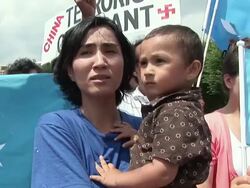 2009 MS ZI Woman holding toddler and shouting slogans during an anti-China protest in support of the Uygurs/ Washington D.C., USA/ AUDIO Stock Footage