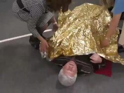 HD: Students Protecting Injured Person With Foil Blanket Stock Footage