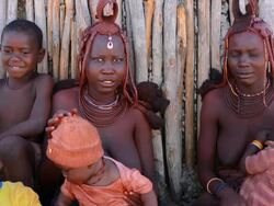 CU Shot of Himba tribe two young women friends with braids and traditional dress in desert of Hartmann Berge / Namib Desert, Namibia, South Africa Stock Footage