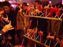MS Shot of Vender making sugar figurine in park when Spring Festival / Xian, China Stock Footage