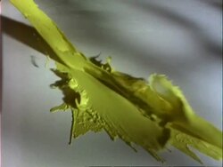 Yellow paint slashes onto white canvas Stock Footage