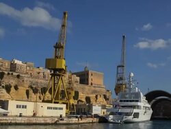 YELLOW CRANES AND GOLDEN ODYSSEY YACHT Stock Footage