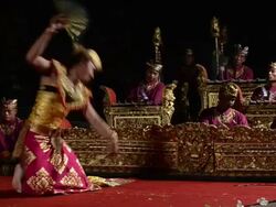 MS TS Balinese dancer is performing Kebyar Terompong Dance in front of Gamelan orchestra in Puri Saraswati temple AUDIO / Ubud, Bali, Indonesia, Asia Stock Footage