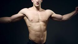 healthy athlete shows good muscle on black background Stock Footage