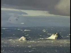 WA view across water toward snowy mountain, Antarctica Stock Footage