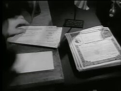 B/W 1944 high angle close up woman's hands sorting Army War Bonds in office / World War II / newsreel Stock Footage