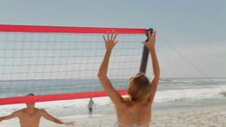 Friends playing beach volleyball Stock Footage