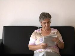 Old Woman and Newspaper Stock Footage