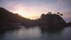 Aerial reveal of the sunrise over a headland in the Burmese archipelago Stock Footage