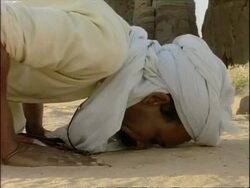 CU Arab man kissing ground, in worship, Algeria, Africa Stock Footage
