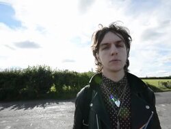 Young rock musician stands at crossroads Stock Footage