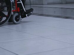 Hospital. Patient sitting in wheel chair and two passers Stock Footage