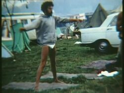 1969 MONTAGE WS ZO Semi-dressed man doing stretching exercises in campsite at Woodstock music festival, MS ZI Stretching in campsite with image of Indian guru on tent/ Bethel, New York, USA Stock Footage