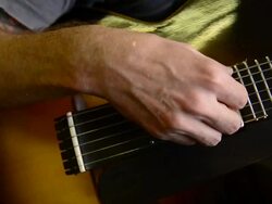 Craftsman 'Luthier' Nigel Forster making hand made Guitars Stock Footage