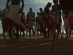 Maasai Ceremony - Warriors jumping up and down, dancing, low angle view, WITH AUDIO Stock Footage