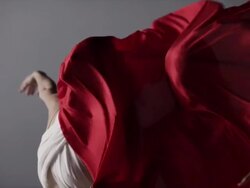 portrait of two woman draped with red silk fabric that moves in wind Stock Footage