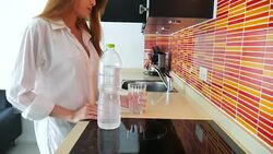 Beautiful woman pouring water into a glass Stock Footage