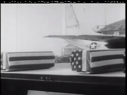 B/W 1960s PAN truck carrying coffins covered in American flags at airport / Vietnam War Stock Footage