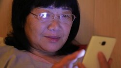 Woman using mobile phone in bedroom Stock Footage