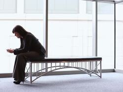  WS Businesswoman sitting on inside bench using PDA / Seattle, Washington, United States Stock Footage