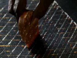 CU Carved wooden comb stamping paint into aboriginal tiwi art / Northern Territory, Australia Stock Footage