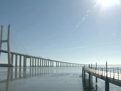 MS View of Vasco da Gama Bridge and catwalk at side on Tagus River from Parque das Nacoes / Lisbon, Portugal Stock Footage