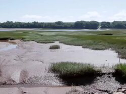 MS PAN Shot of Boat fixed at dock grounded by low tide / Wolfville, Nova Scotia, Canada Stock Footage