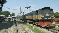  A diesel passenger train with packed carriages idles in a station in Northern Bangladesh before beginning a long journey to Dhaka Stock Footage