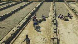 Young men in Bangladesh use simple wooden moulds to fashion bricks from a simple clay and water mix there actions are fast and rhythmical  Stock Footage