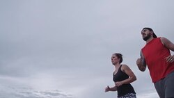 Physically Fit Caucasian Couple in their Thirties Running Stock Footage