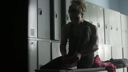Women tying her shoelaces in locker room Stock Footage
