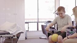 Physical therapist working with teenage boy Stock Footage