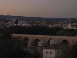 LS PAN evening across Roman bridge to Cathedral-Mosque Stock Footage