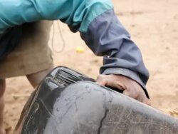 Boy getting water from a small well Stock Footage