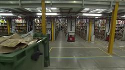 Staff working in a busy Amazon warehouse on Black Friday News Clip