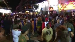 Mardi Gras participants crowd Bourbon Street in New Orleans. Stock Footage
