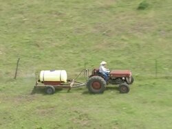 WS AERIAL View of Farmer Sprinkling medicine on farmland  / Oklahoma, United States Stock Footage