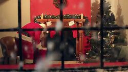 Father Christmas delivering presents through window Stock Footage