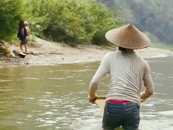 MS TS SLO MO Shot of woman in traditional conical hat picking green algae in middle of river / Ou river, Luang Prabang, Laos Stock Footage