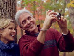 MS Mature couple taking pictures of fall color in the wood / Sea Bright, New Jersey, USA Stock Footage