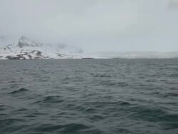 Cloudy, stormy and foggy weather at Isfjorden, the second longest fjord in the Norwegian archipelago of Svalbard; mountains covered by snow Stock Footage