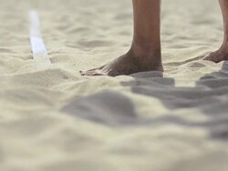 ECU of female beach volleyball players feet and legs as she serves. Stock Footage
